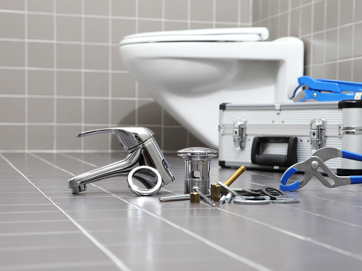 A toilet being installed in a commercial building